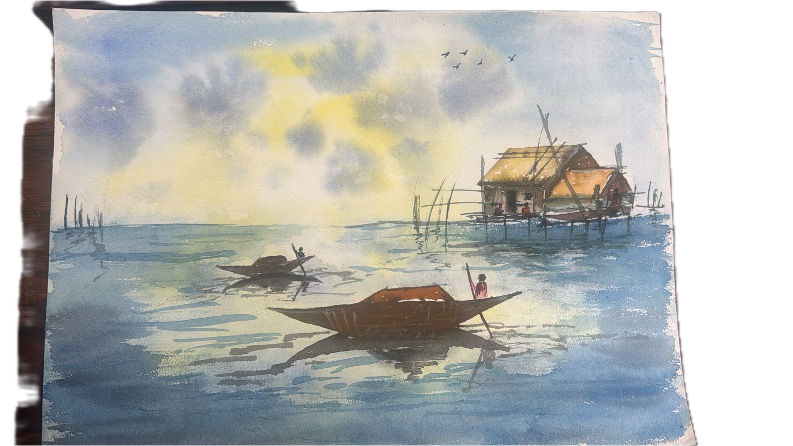 Fishing boats and stilt house at sunrise